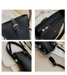 Detailed close-up of the black bucket bag showing zipper, metal studs and adjustable strap