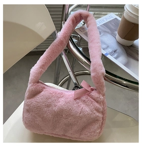 Detail shot of a pink fluffy faux fur underarm bag with a sweet decorative bow knot