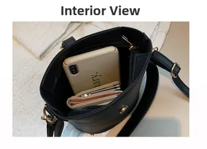 Top view of the spacious black bucket bag interior showing phone and wallet storage