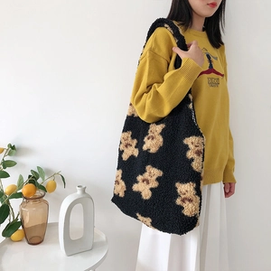 Fuzzy black sherpa tote bag with brown teddy bear pattern and large shoulder capacity