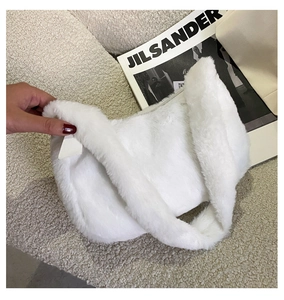 Close-up of white plush handbag with soft lamb wool texture and elegant cloud shape