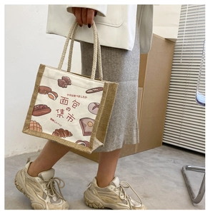 Detailed close-up of a canvas and jute tote bag with artistic Japanese bread illustrations