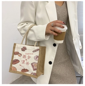 Close-up of canvas and linen tote bag featuring hand-drawn bread prints and woven handle