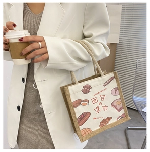 Detail of canvas tote featuring bread illustrations and hemp rope handles