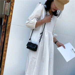 Minimalist black mini crossbody bag with double buckles and stylish chain strap for women