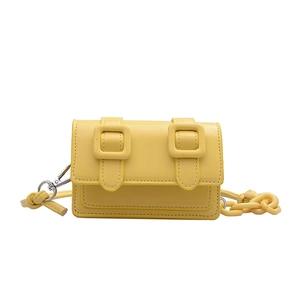 Mini yellow crossbody bag with rectangular shape and decorative buckles in bright synthetic leather