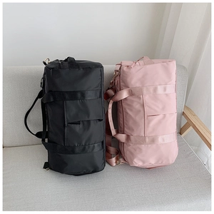 Sacs de voyage imperméables en noir et rose sur un canapé en tissu gris