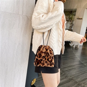 Chic faux fur leopard print bucket bag with drawstring closure and slim shoulder strap