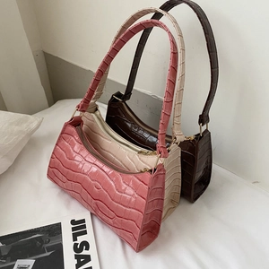 Three crocodile embossed underarm bags in pink, cream, and coffee PU leather with gold hardware