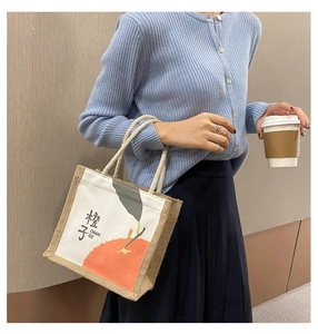 Detail of canvas tote bag with orange print and thick cotton rope handle for women
