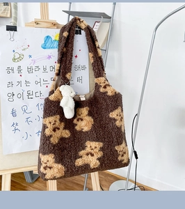 Dettaglio borsa tote in peluche marrone con motivi di orsi e trama morbida