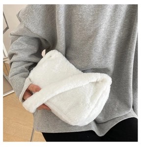 Detail showing soft white plush texture and minimalist design of the fluffy shoulder bag