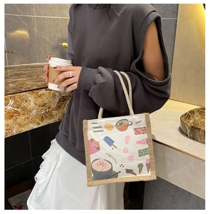 Detail of small canvas tote bag with colorful summer illustrations and braided handles