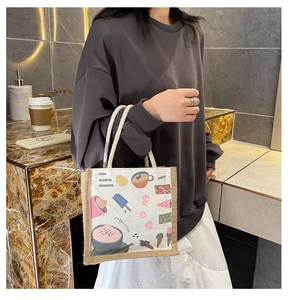 Detail of canvas tote bag featuring Summer Festival cartoon illustrations and rope handles