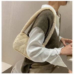 Chic beige faux fur underarm bag shown with a model for an autumn winter style look