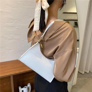 Elegant white crocodile embossed baguette shoulder bag for women in a natural setting