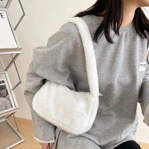 Minimalist white faux fur shoulder bag with plush strap shown on model for autumn winter
