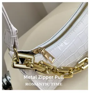 Detail of white crocodile pattern shoulder bag with premium gold hardware and zipper