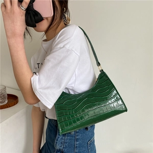Dark green baguette shoulder bag with faux crocodile pattern and golden zipper detail