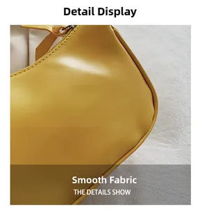 Detail shot of smooth yellow faux leather fabric with neat stitching and matching zipper