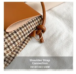 Detail of the knotted leather strap and vintage houndstooth fabric on the crossbody bag