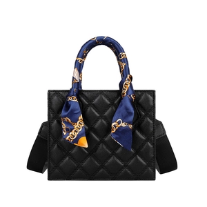 Classic black quilted square handbag with silk scarf handle and wide shoulder strap