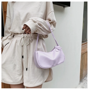 Close-up of a lilac crescent underarm bag featuring a delicate bow knot detail