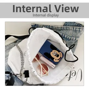 Internal view of a white canvas bucket bag showing capacity for phone and sunglasses
