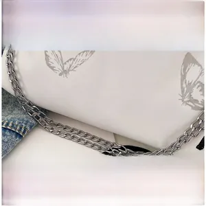 Detail of white butterfly bucket bag with silver metal chain straps and black drawstrings