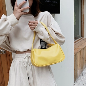 Retro minimalist bright yellow PU leather baguette shoulder bag shown on female model