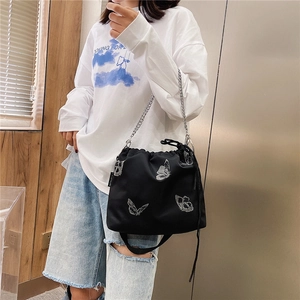 Fashionable black drawstring bucket bag with silver butterfly embroidery and chain strap