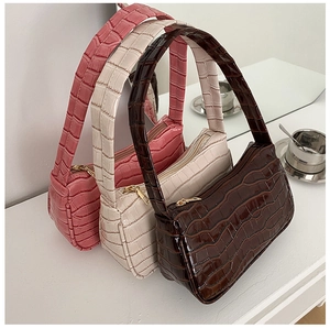 Three colors of faux crocodile leather baguette bags in dark brown, white and pink colors