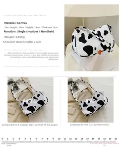 Detail of cow print canvas tote bag showing dimensions 22x14x8cm and zipper closure