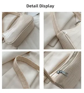 Détails du sac baguette crème effet crocodile avec fermeture éclair en métal et coutures