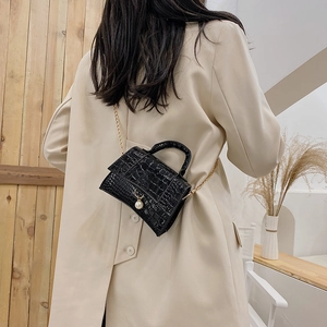 Mini black crocodile embossed crossbody bag with gold chain and pearl pendant charm