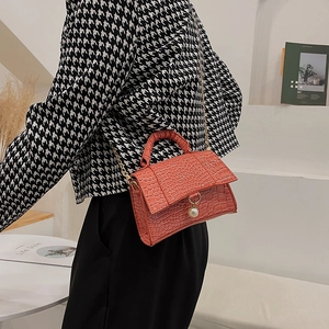 Elegant coral orange crocodile pattern handbag with pearl pendant and gold chain strap