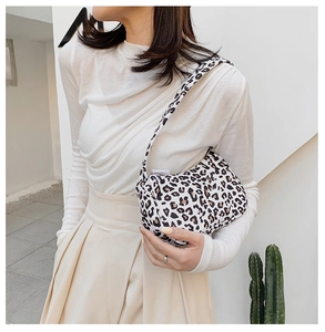 Classic leopard print underarm bag shown styled with a white top and beige trousers