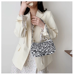 Fashionable zebra print shoulder bag styled with a neutral blazer for daily wear