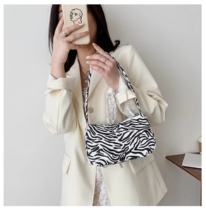 Detail view of stylish zebra print shoulder bag styled with a modern outfit for women