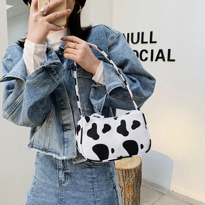Fashionable cow print tote bag for women, stylish streetwear shoulder handbag in black and white