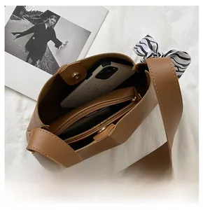 Spacious interior of brown leather tote bag with inner pouch and silk scarf detail