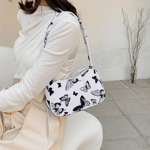 Fashionable white baguette tote bag with black butterfly print and matching shoulder strap