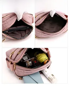 Detailed view of pink nylon crossbody bag showing multiple zippered storage compartments