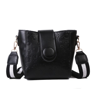 Retro black bucket bag with embossed heart patterns and black white striped wide strap