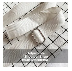 Detail of white woven adjustable shoulder strap with silver metal buckle on checkered background