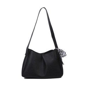 Elegant black minimalist shoulder bag with pleated design and zebra scarf accessory