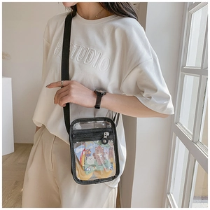 Detail of transparent PVC crossbody bag with black webbing and adjustable strap for women