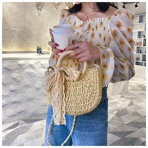Chic beige woven straw handbag with a large lace bow and circular top handle for summer