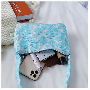 Vue détaillée du sac en toile brodé avec espace pour téléphone et produits cosmétiques