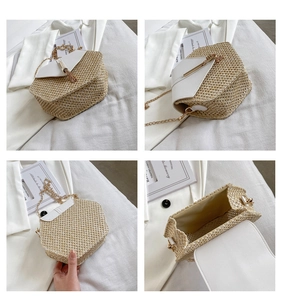 Detail view of hexagonal woven straw crossbody bag with white leather flap and gold chain strap